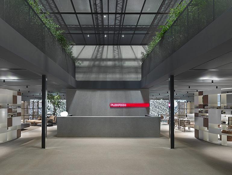The reception desk inside the Flexform stand at the Salone del Mobile 2023